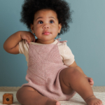 Ainur Berkimbay's Pinwheel Baby Romper knitting pattern in Purl Soho's Stormy Superwash Sock yarn